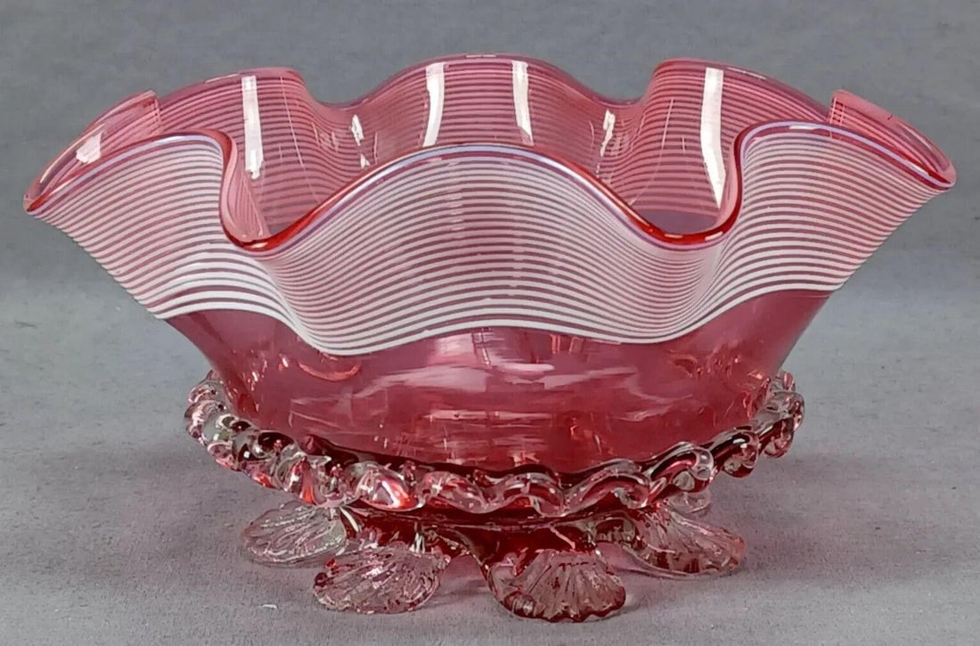 Stourbridge Threaded Cranberry Victorian Bowl: Nice antique English Stourbridge hand blown Victorian art glass cranberry ruffled bowl. With white threading, applied clear glass rigaree and applied clear glass feet. Rough pontiled base. Circa 1880