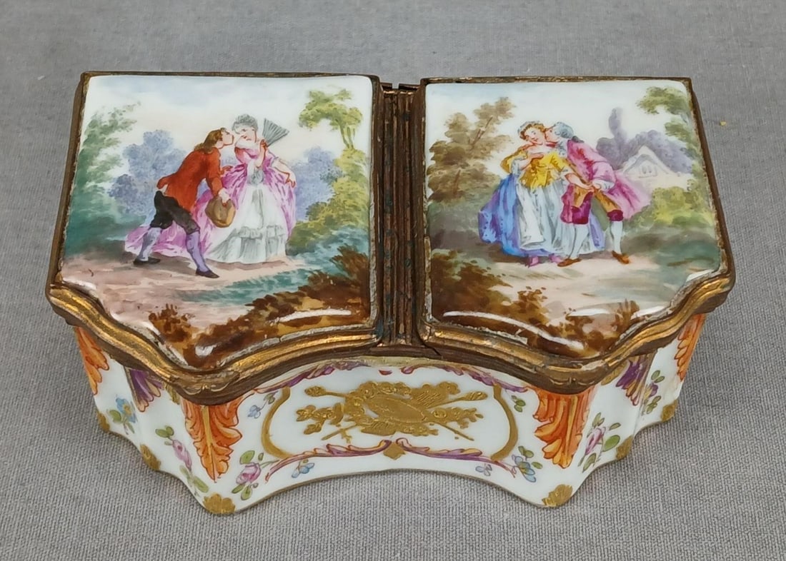 Samson Paris Hand Painted Watteau Scene Box: Antique French porcelain double sided trinket box. Decorated with hand painted watteau courting couple scenes on the lids. Decorated with raised gold flowers and arrows on the sides, small hand painte