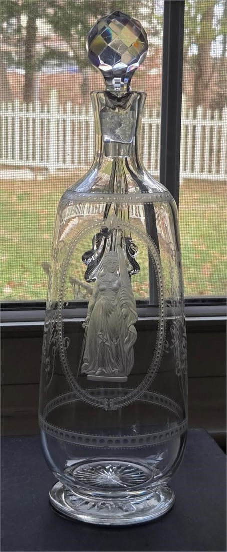Stourbridge Decanter Woman W/ Crown C. 1870s: Antique hand blown Stourbridge English glass claret footed decanter, possibly Thomas Webb & Sons. It has a clear oblong body with a center engraving of a woman with a crown in a long flowing dress hol