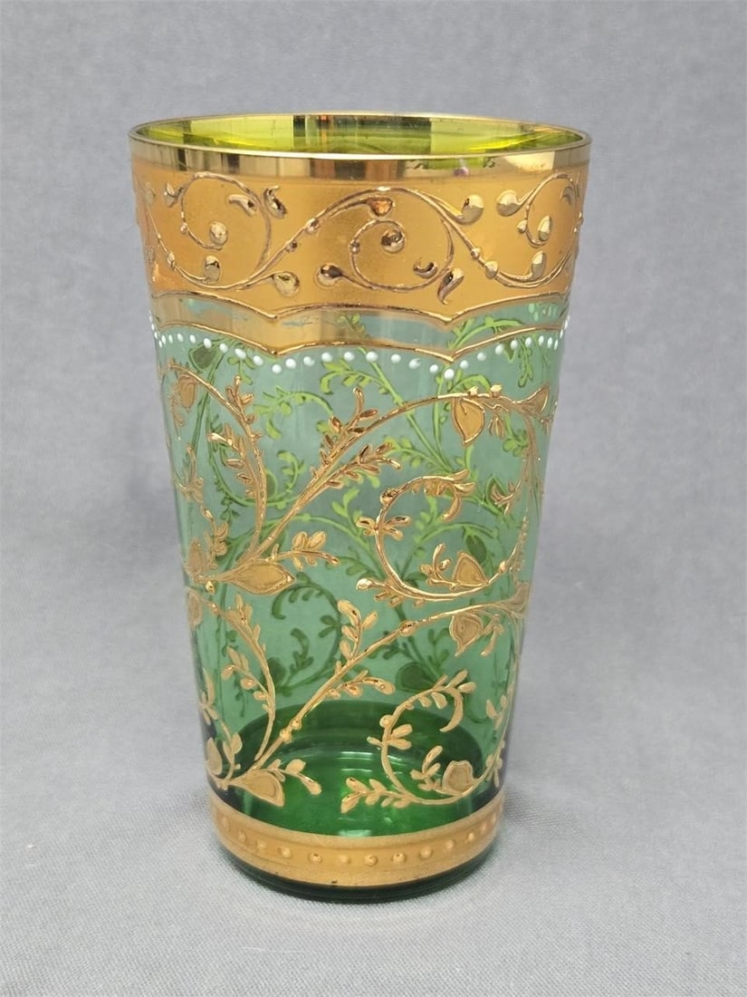 Signed Moser Bohemian Green Juice Glass: Bohemian green juice glass with gold gilt and enamel. Signed Moser on the bottom. There is some loss to the gold gilt on the sides and rim. No chips or cracks. Measures approximately 3 3/4 inches tall