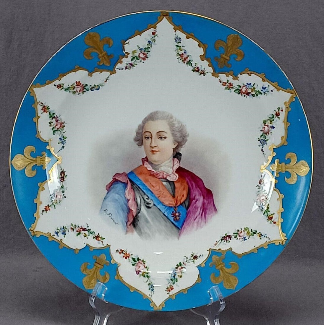 Sevres Style Hand Painted King Louis XV Charger: Nice late 19th century Sevres style porcelain charger. Decorated with a hand painted portrait of King Louis XV over a white background. Framed by a celeste blue border with gold fleur de lys and scrol