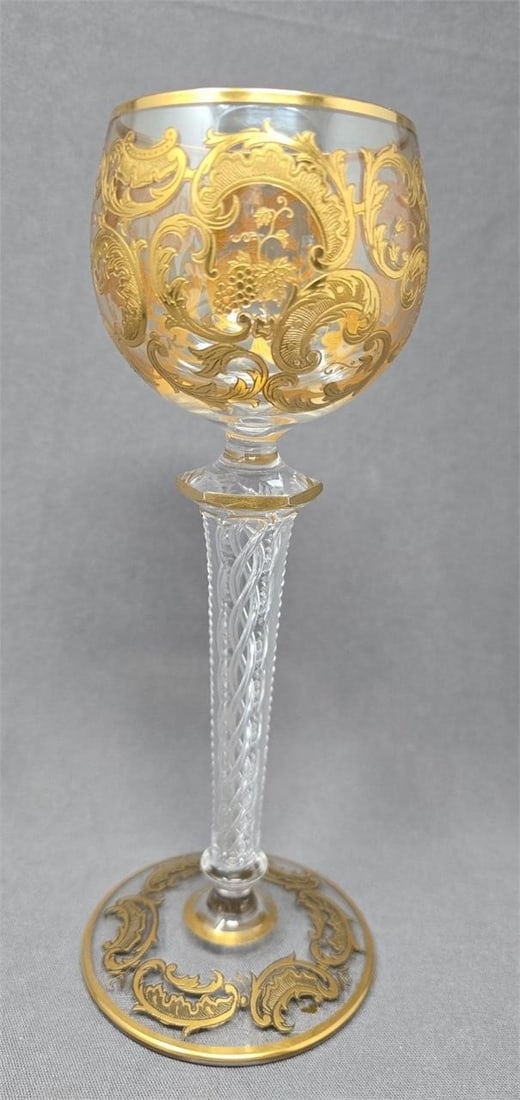Saint Louis Hock Wine Air Twist Stem: Unmarked antique St. Louis hock wine. It has a cut air twist stem with beading on facet edges. It has a 6 sided knop near the bowl and smaller knop near the base. Gold scrollwork with grapes on the bo
