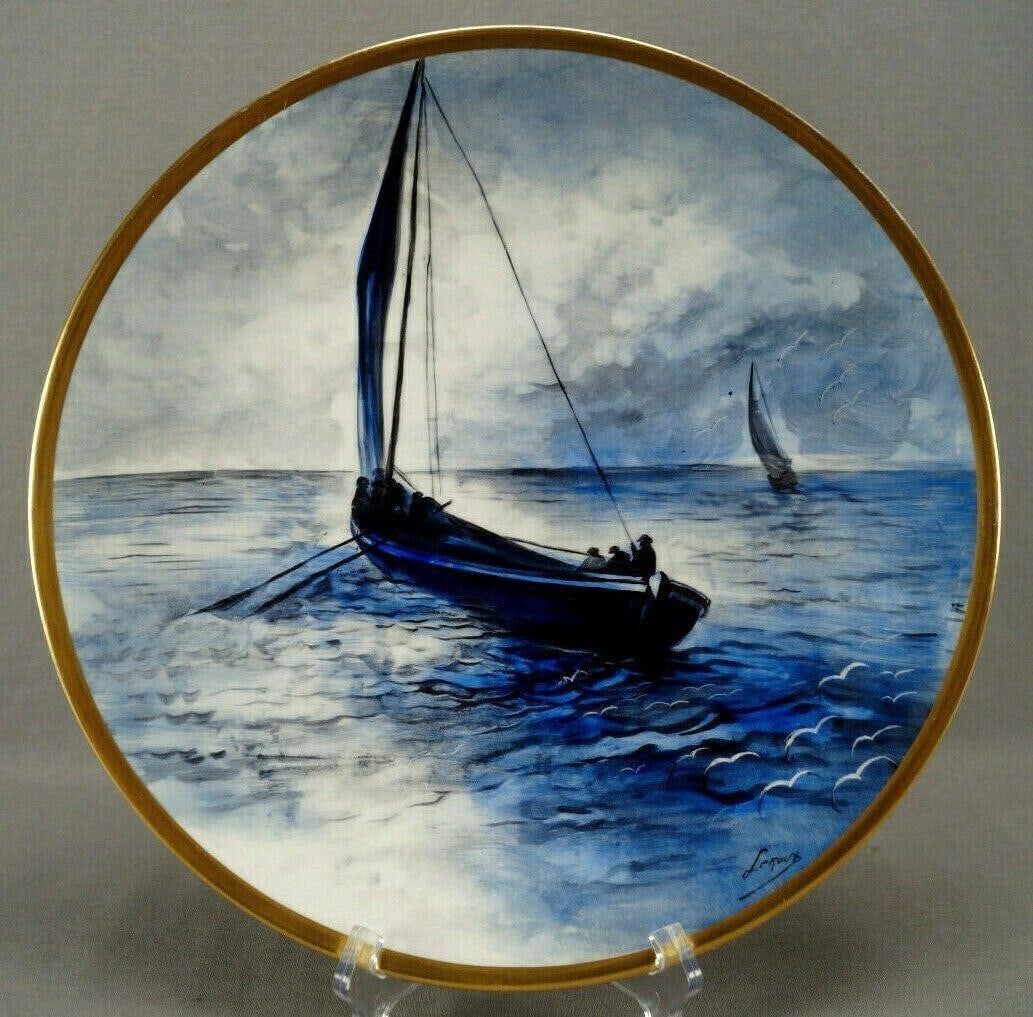Limoges Hand Painted Maritime Scene Blue Charger: Nice antique porcelain charger. Decorated with a hand painted maritime scene with a central sailboat with men rowing and another sailboat in the background. Painted in shades of blue, grey, and black.