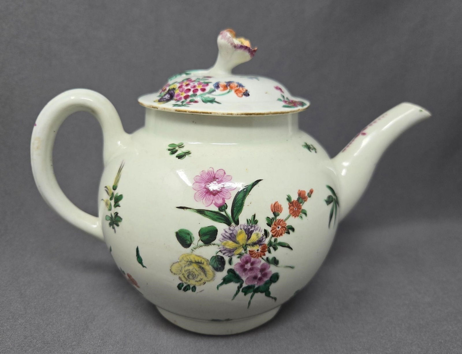 Worcester Dr Wall Period Teapot: Antique Worcester floral teapot with flower finial lid. Circa 1765. It has old repairs to lid and inside wall and a visible crack on the lid. There is also a stress crack on the spout. Unsure to
