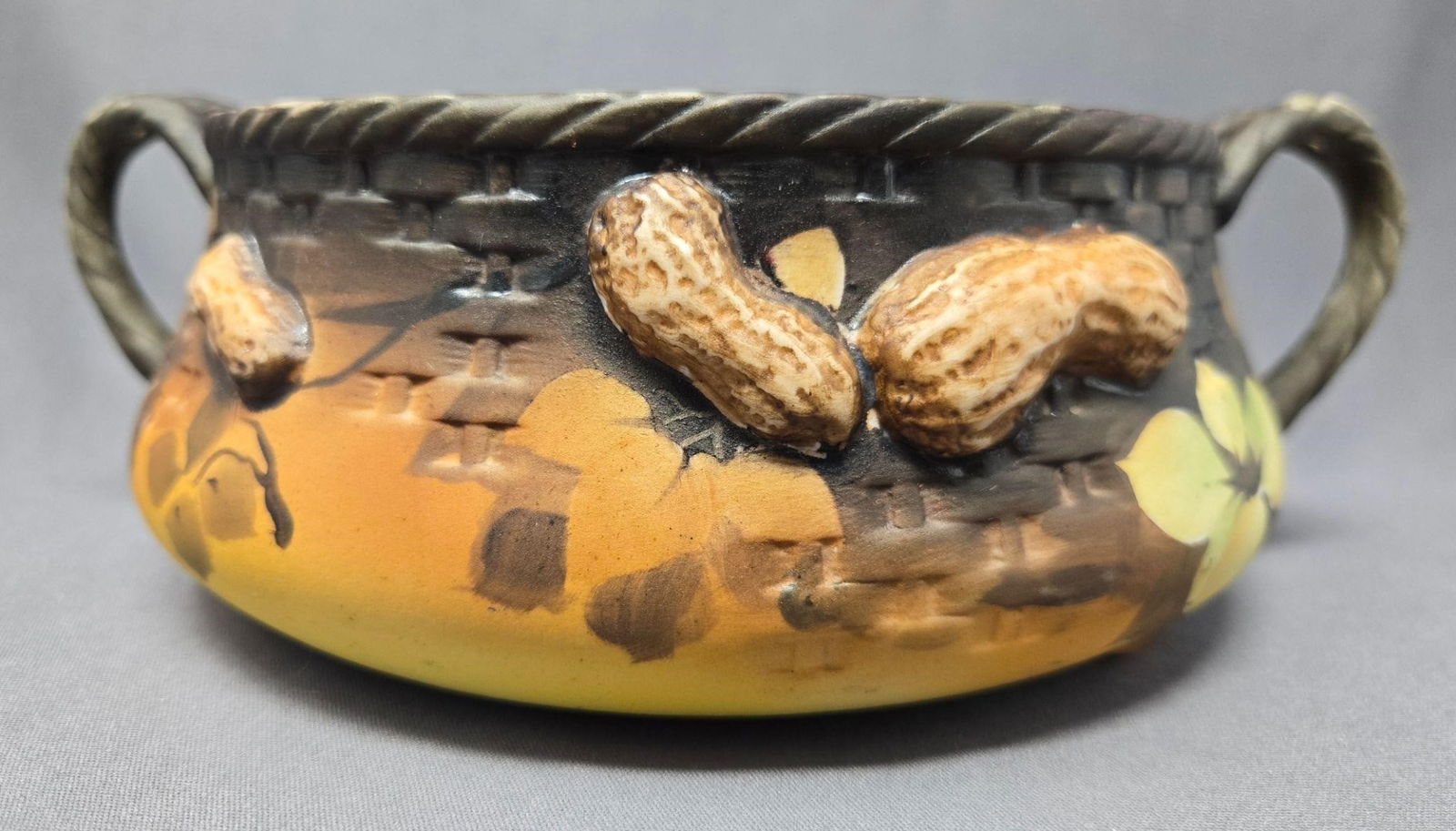 Morimura Brothers Peanut Basket: Hand Painted Nippon Morimura Brothers porcelain basket with raised peanut design. Post 1911. Measures approximately 3 inches tall, 9 inches from handle to handle and the opening diameter is 6 3/8 inch