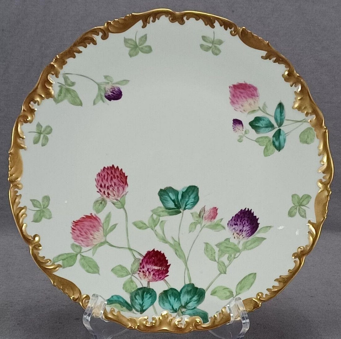 Limoges Clover Flowers & Gold 9 3/8 Inch Plate C: Nice antique porcelain plate. Nicely decorated in the clover pattern with pink and purple clover flowers and green clover leaves. With heavy gold gilding along the edge. Made by Tressemann & Vogt in L