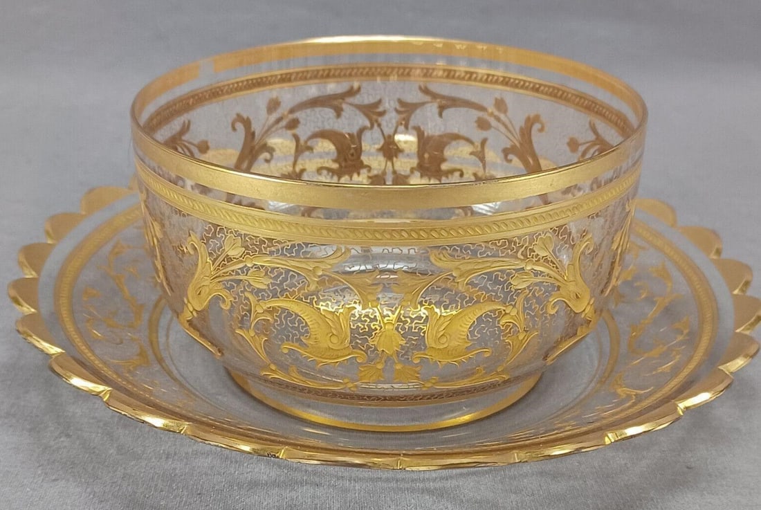 Moser Type Engraved & Gold Scrollwork Finger Bowl: Nice antique Bohemian or German hand blown clear glass finger bowl and under plate. Decorated with an engraved and gilt Art Nouveau floral scrollwork pattern with vermicelli gilding and gold bands. Ha