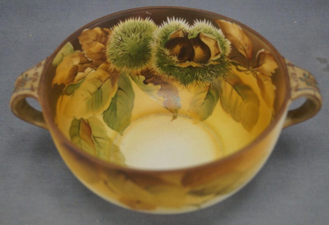 Nippon Raised Enamel Chestnuts Beaded Handled Bowl: Nice antique porcelain handled bowl. Hand painted with chestnuts over a brown and yellow background. Raised black and turquoise beading and red scrollwork to the beige handles. Marked on the bottom Ha