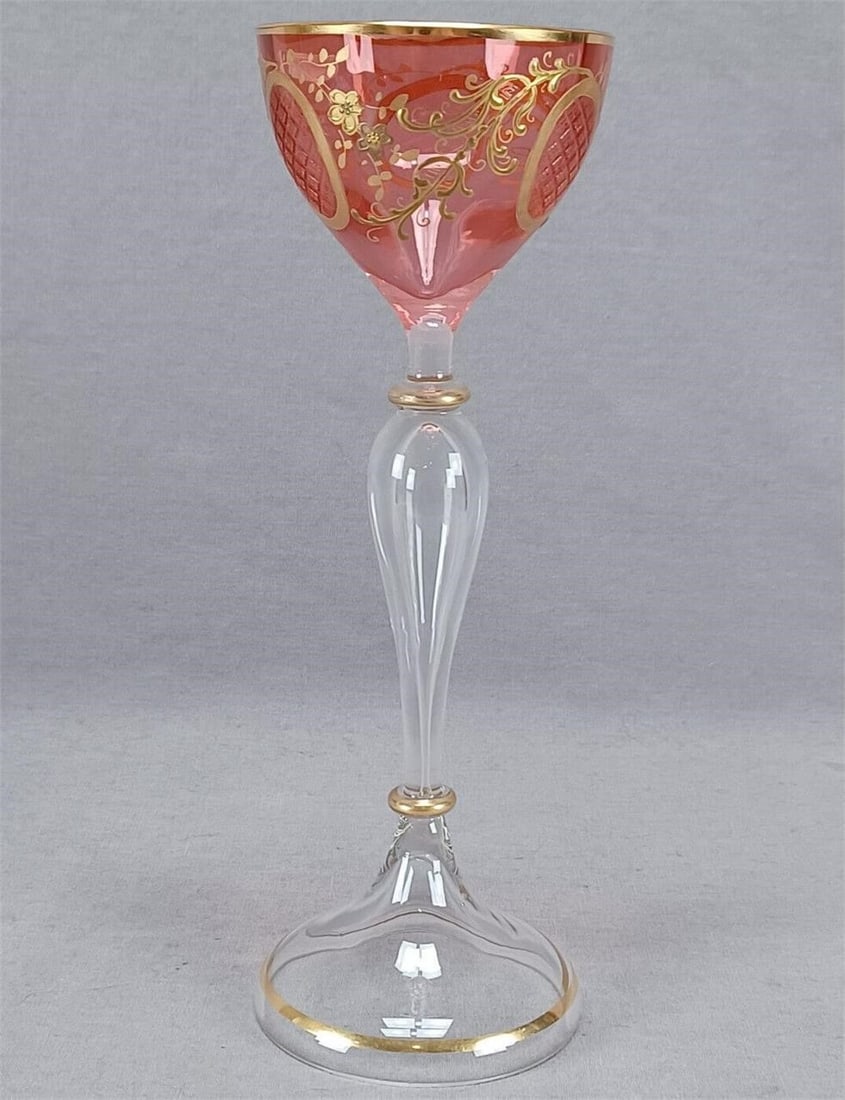 Bohemian Raised Gold Floral & Cut Cranberry Wine B: Nice antique Bohemian blown hock wine glass. Cranberry bowl with raised floral floral scrollwork and gold medallions with cut strawberry diamond pattern. Clear stem with gold highlights. Unmarked. Cir