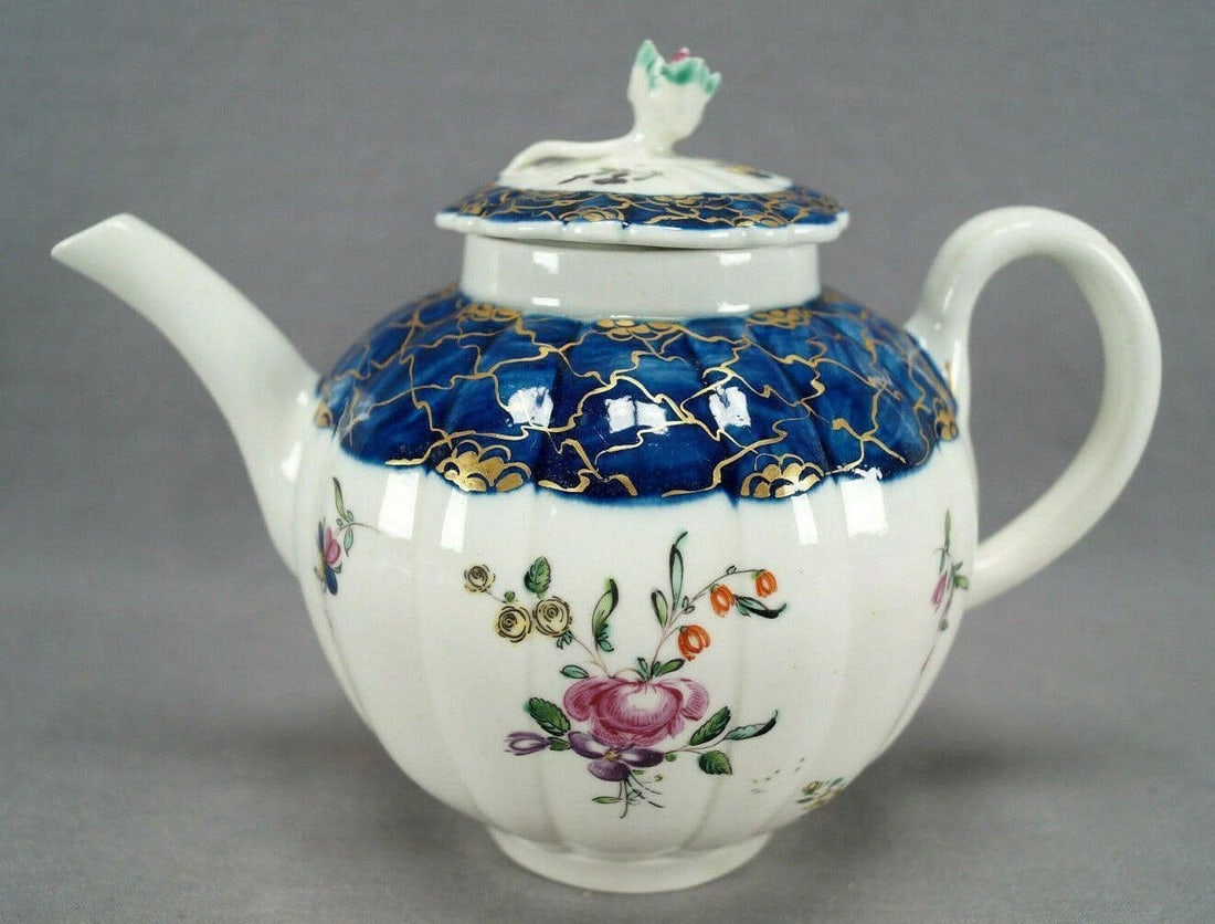 Liverpool Hand Painted Floral & Gold Teapot C 1765: Very nice early fluted porcelain teapot with relief molded floral finial. Decorated with hand painted flowers in pink, purple, yellow, red and blue. With a cobalt blue collar with gold gilt overlay. U
