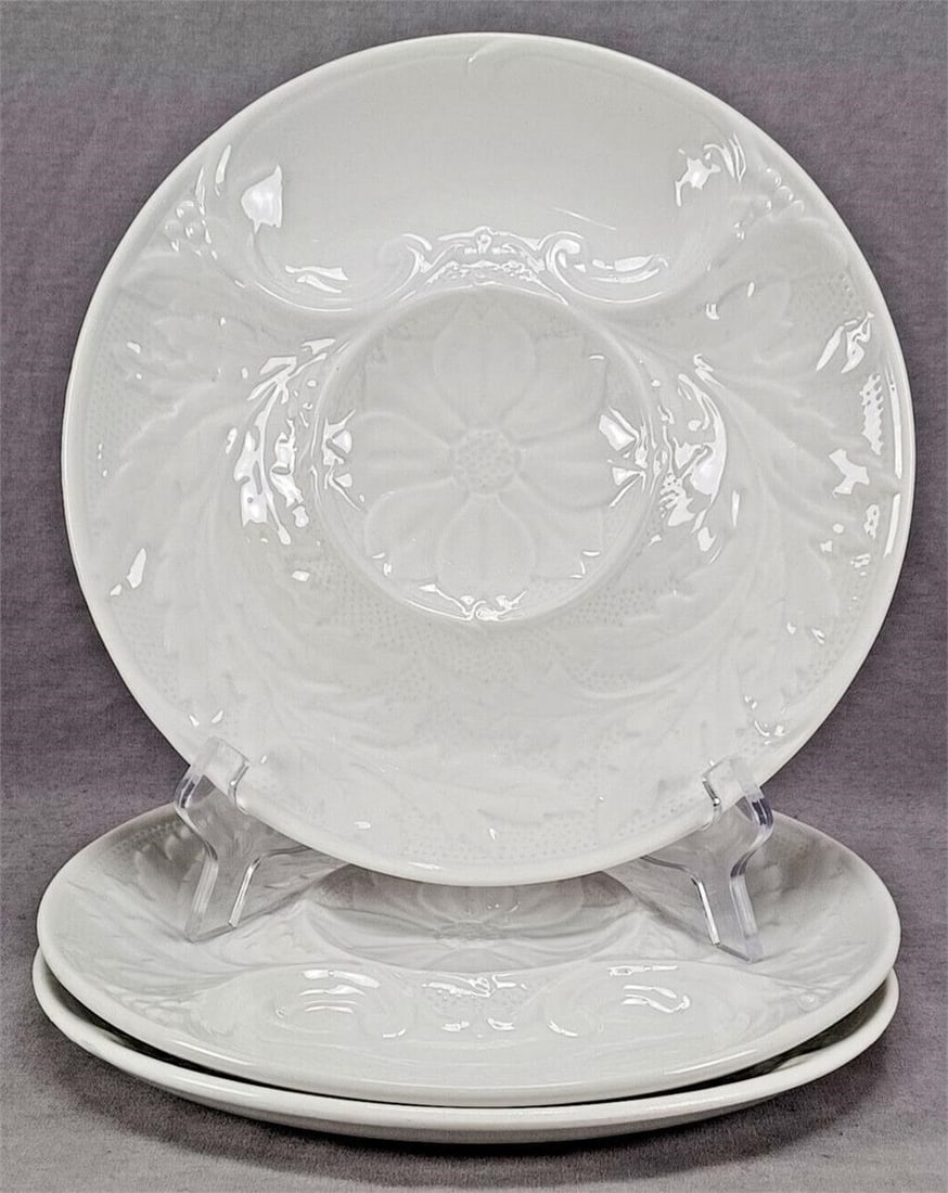 3 Gien White Majolica Oyster Artichoke Plates: Set of 3 French white glazed majolica faience artichoke or oyster plates with relief molded floral design. Marked on the reverse in black Gien France PV France. This mark was used between 1938 and 196