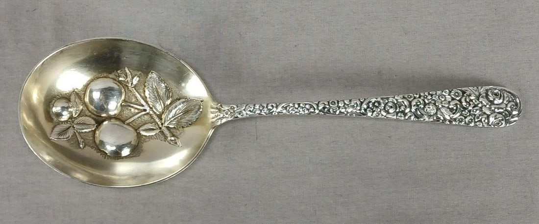 Jacobi & Jenkins Repousse Sterling Berry Spoon: Antique sterling silver large berry / casserole spoon in the Repousse pattern with fruit in the bowl. Marked Sterling 925/1000 Jacob & Jenkins on the back of the handle for Jacobi & Jekins, Baltimore,