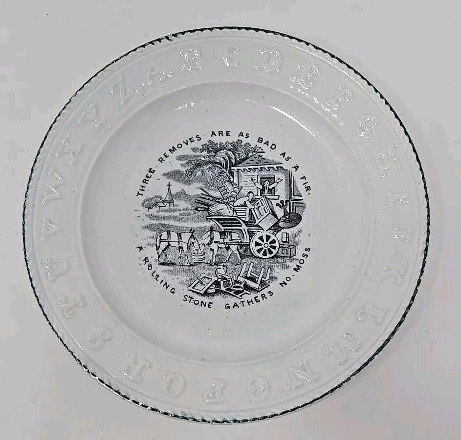 Staffordshire ABC Child's Plate With Saying 8 1/4: Staffordshire childs ABC plate. It has a couple packing furniture with the saying "Three Removes are as Bad as a fire and A rolling Stone Gathers no Moss". Black transfer with green painted border. 