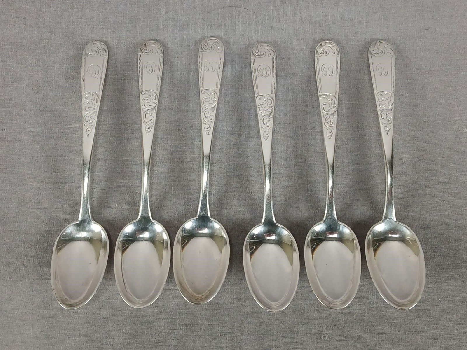 6 Kirk & Sons Coin Silver Mayflower 5 3/4" Spoons: Set of 6 antique American coin silver spoons in the Mayflower pattern. Engraved scripted GJD monogram on the front of the handle. Marked S Kirk Sons and 10:15. Circa 1861 to 1868. These have some wear