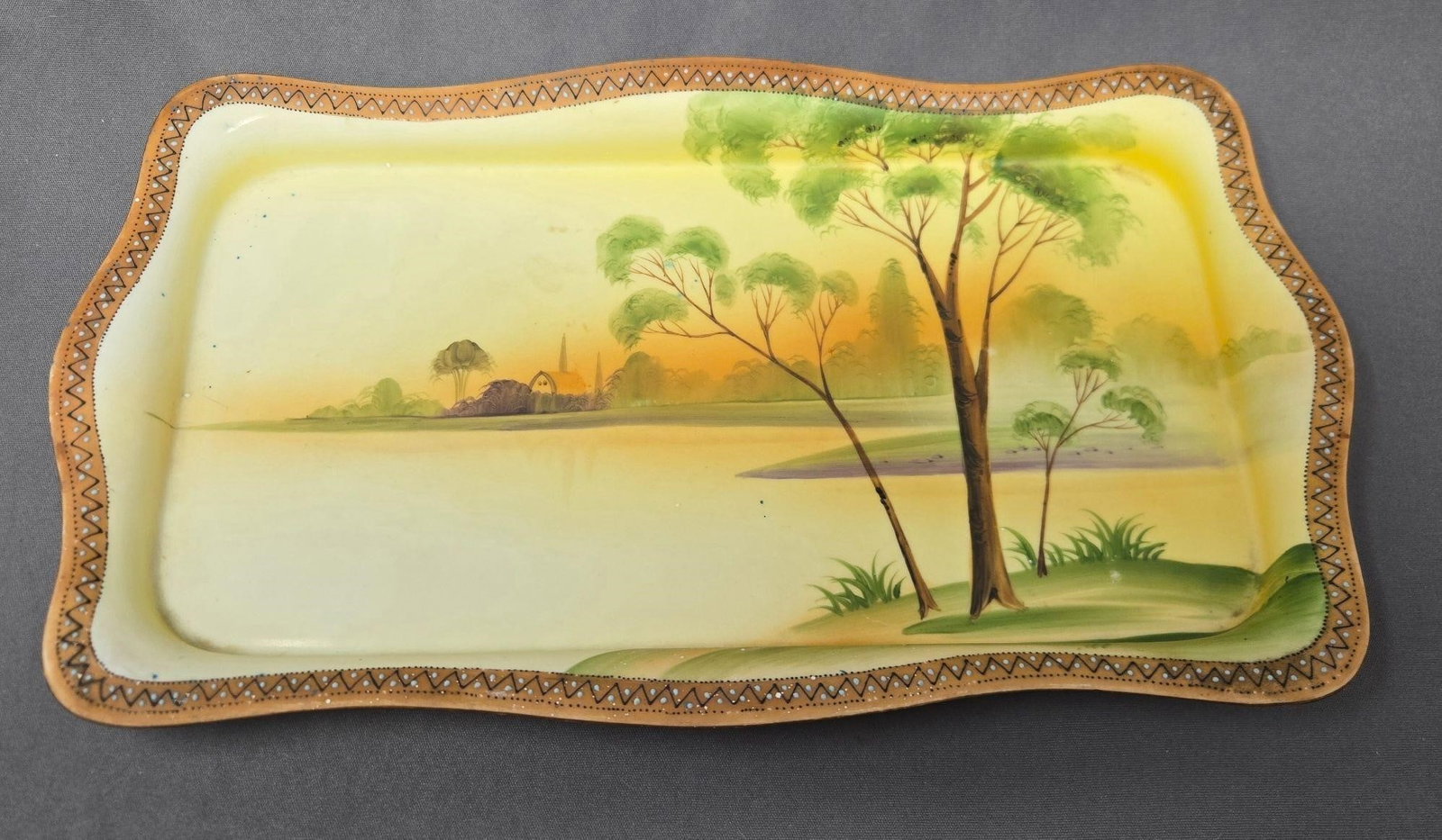 Hand Painted Nippon Ice Cream Tray: Hand Painted Nippon ice cream tray. It has a very faded mark that looks like a maple leaf with the work Nippon, which would make it circa 1891 to 1920s. Water and country side scene. Measures approxim