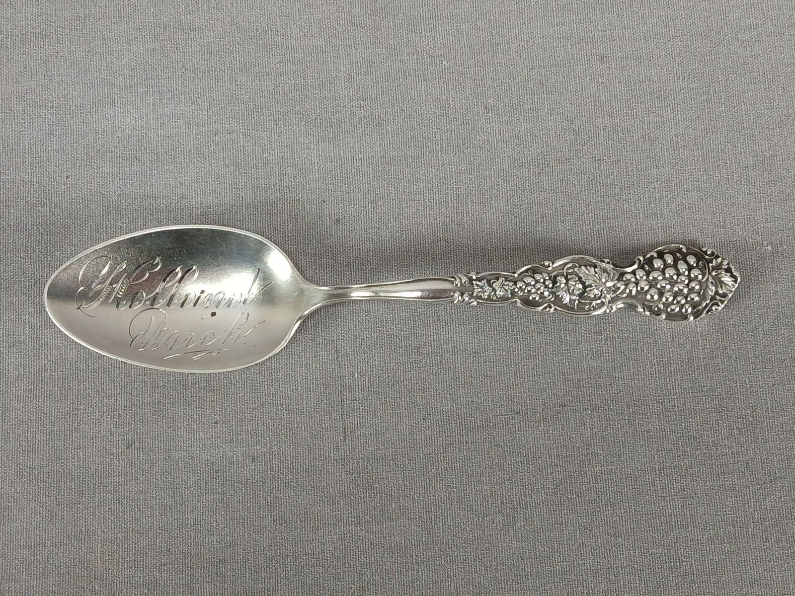 Shepard Holland Michigan Sterling Souvenir Spoon: Antique sterling silver souvenir spoon. Repousse grape handle. Engraved Holland Michigan in the bowl. Marked S on the back of the handle for Shepard Mfg Co, Melrose Highlands, MA and marked Sterling.