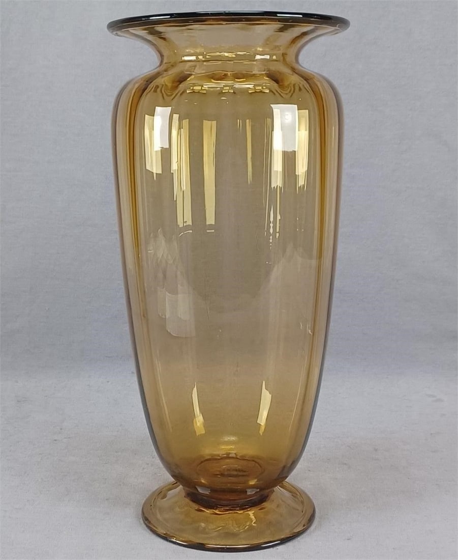Steuben Amber Transparent Glass 9 7/8 Inch Vase: Nice vintage blown amber transparent optic ribbed glass vase. Steuben shape #2908. Rough pontiled base. Has a partial Steuben Fleur de Lis mark on the base.Good condition other then a few scratches to