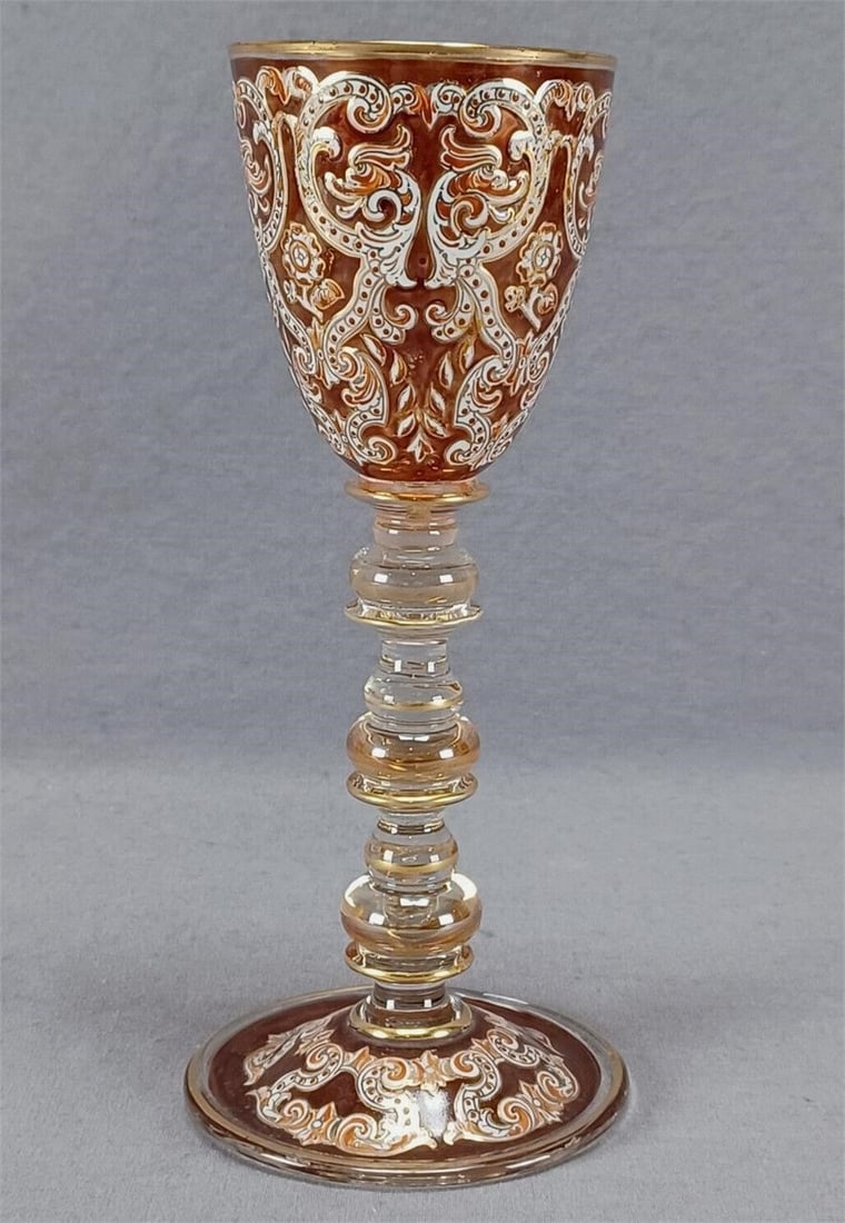 Fritz Heckert Neoclassical Dolphins Wine Glass: Nice antique hand blown pale amber luster wine glass. Decorated with hand enameled Neoclassical dolphins, scrollwork, and flowers in white, red, and orange over an orange enamel background. Gold gildi