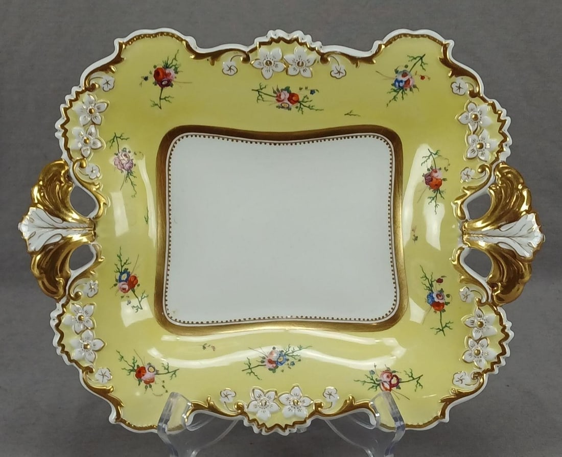Davenport Yellow & Floral Dessert Dish C. 1815-25: Antique British bone china dessert dish with relief molded flowers with gilt highlights. Has a yellow border with hand painted flowers in pink, orange purple, white, and blue. Gold gilding along the e