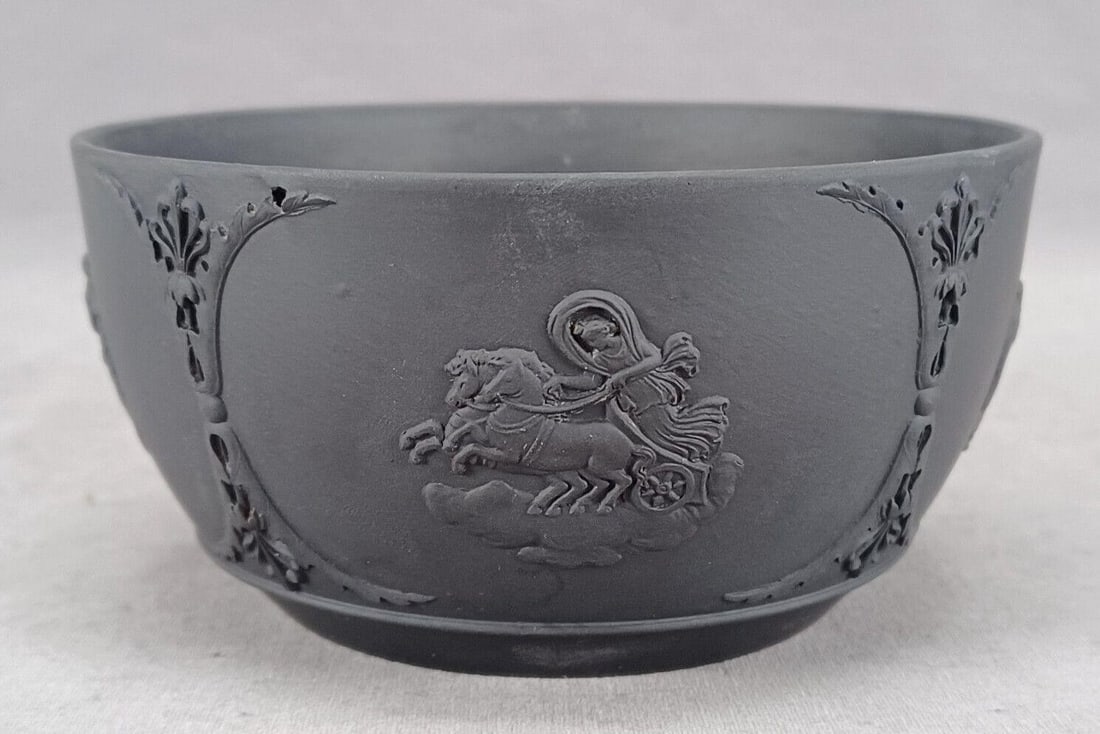 19th Century Wedgwood Black Basalt 4 1/2 Inch Bowl: Antique 19th century British Wedgwood black basalt bowl. With Neoclassical black sprigs. Impressed Wedgwood on the base.Has some white scratches along the inside of the bowl, and a small hole to the s