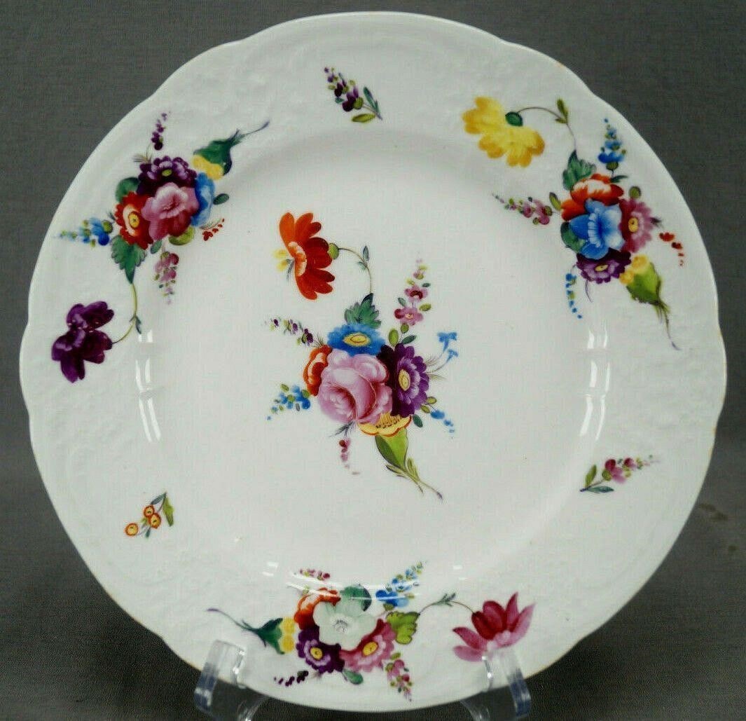 Coalport Floral Molded Edge 9 1/4" Plate C 1820 A: Nice porcelain plate with molded floral scrollwork edge. Decorated with hand painted flowers in purple, pink, blue, red, yellow, and white. Unmarked except for an impressed number. Made by Coalport. C