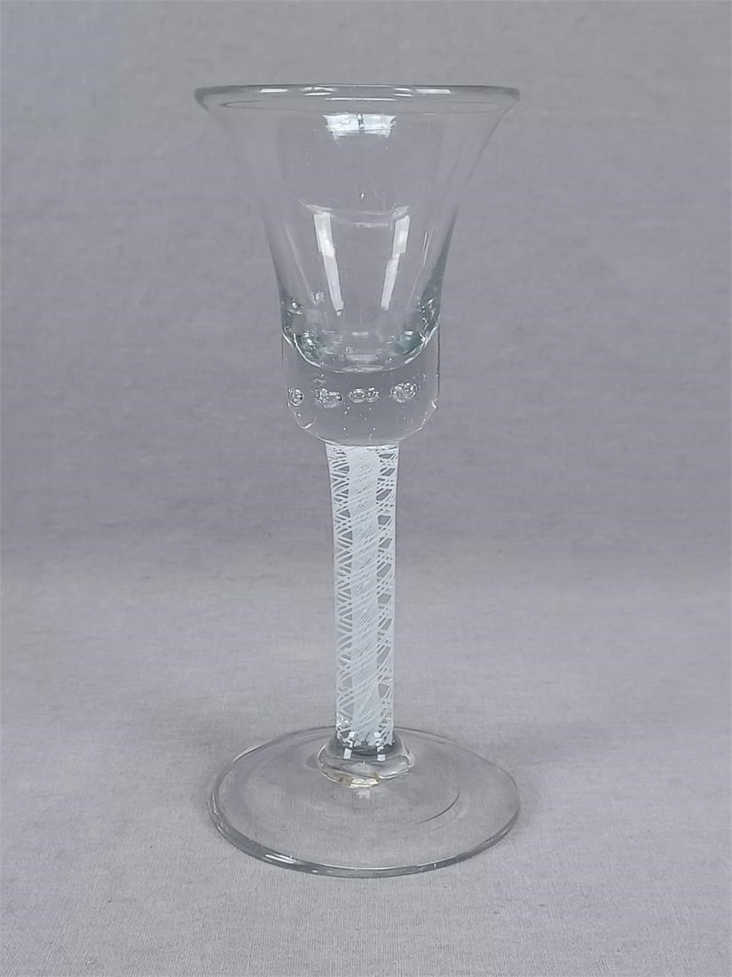 18th Century Flint Glass Double Opaque Twist Wine: 18th century continental hand blown flint glass wine. Probably Dutch. With opaque twist stem. Controlled bubbles in the bottom of the bowl. Rough pontiled base. Circa 1750.Good condition with no