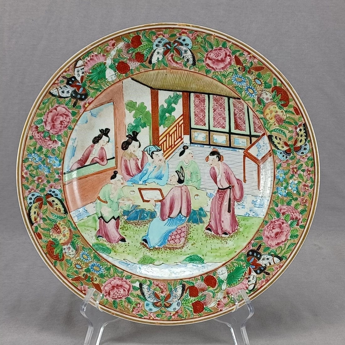 Antique British Rose Mandarin Earthenware Plate: Antique 19th century British earthenware plate. Decorated in the Chinese "Rose Mandarin" style with hand painted enamel Asian figures with a border of butterflies and flowers over gold. Gold gilding