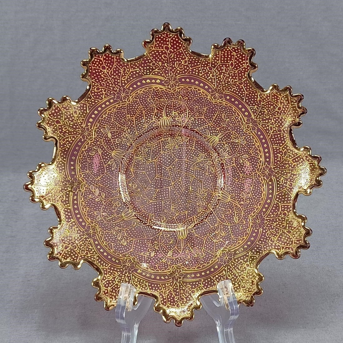 Moser Harrach Floral Cranberry Glass 7 3/4" Plate: Nice antique late 19th century Bohemian blown cranberry glass plate. Heavily decorated with raised yellow gold floral scrollwork, crackle pattern, and beading. Gold gilding along the edge. Ground and