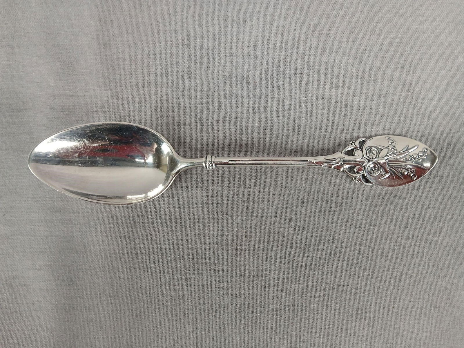 Gorham Lily 1870 Sterling Silver 5 7/8" Teaspoon: Antique sterling silver teaspoon in the Lily pattern by Gorham. Monogrammed ECJ on the back of the handle. Hallmarks for Gorham, PAT '70 and Sterling on the back of the handle.Has some wear and tarnis
