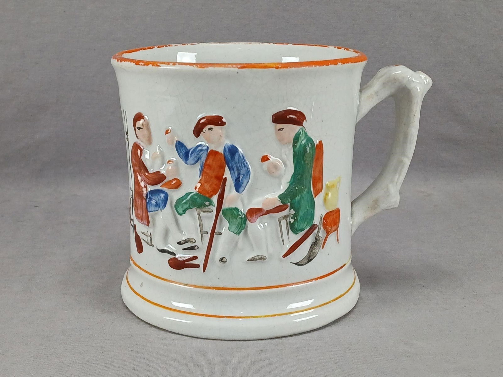 Staffordshire Surprise Frog 5 1/2" Mug / Tankard: 19th century British Staffordshire hand enameled relief molded frog surprise mug / tankard. Orange ocher trim. Unmarked. Has crazing typical of earthenware, staining, and wear to the enamel, and an in