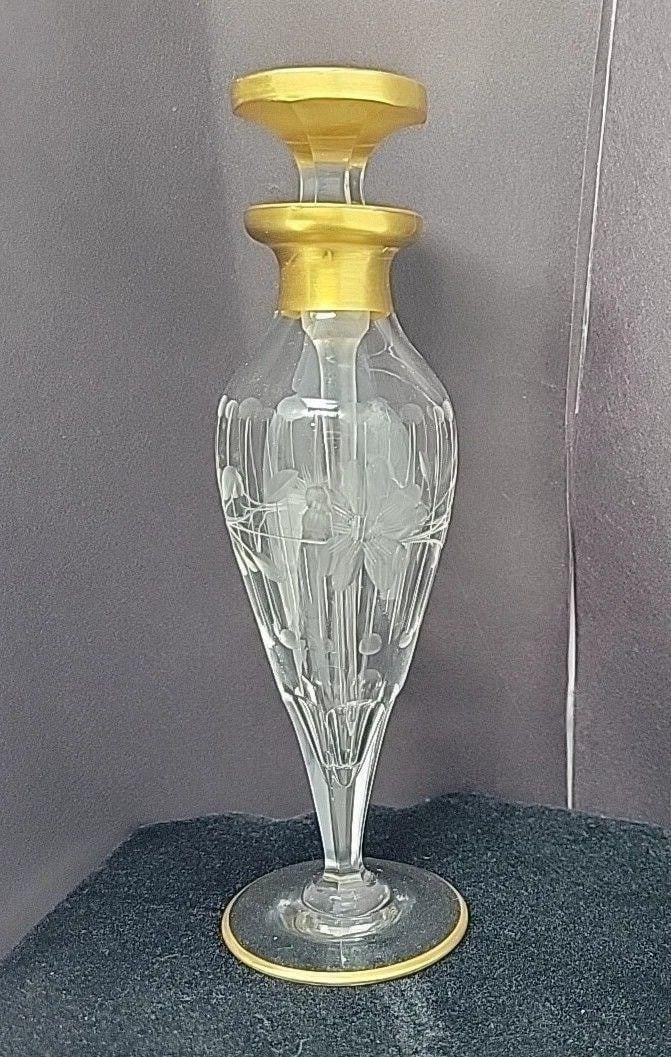 Floral Etched Crystal Perfume / Cologne w/ dauber: This is an etched crystal perfume / cologne with a Hexagon stem and thumbprint carvings above. It is etched with a floral, line, and circle design and has a gold panted top and rim around base. It has