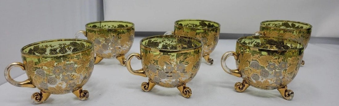 Set of 6 Antique Moser 3 Footed Punch Cups: Set of 6 Antique Moser glass 3 footed and handled green to clear punch cups with gilt floral and berries decor. Very nice, attached glass scroll legs and handles. No chips or cracks, some loss of gold