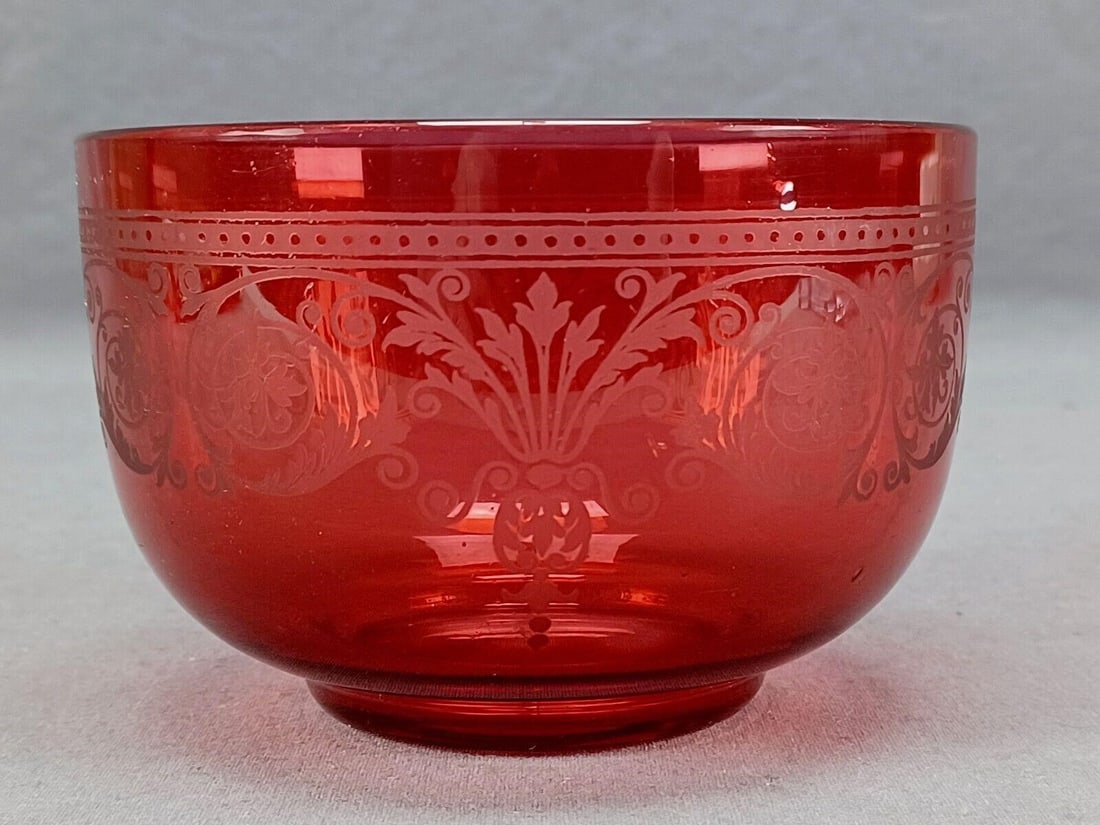 19th Century Etched Neoclassical Cranberry Bowl: Nice antique late 19th century French hand blown cranberry glass finger bowl. With acid etched Neoclassical scrollwork. Ground and polished pontiled base.Good condition.Measures approximately 4 1/2 in