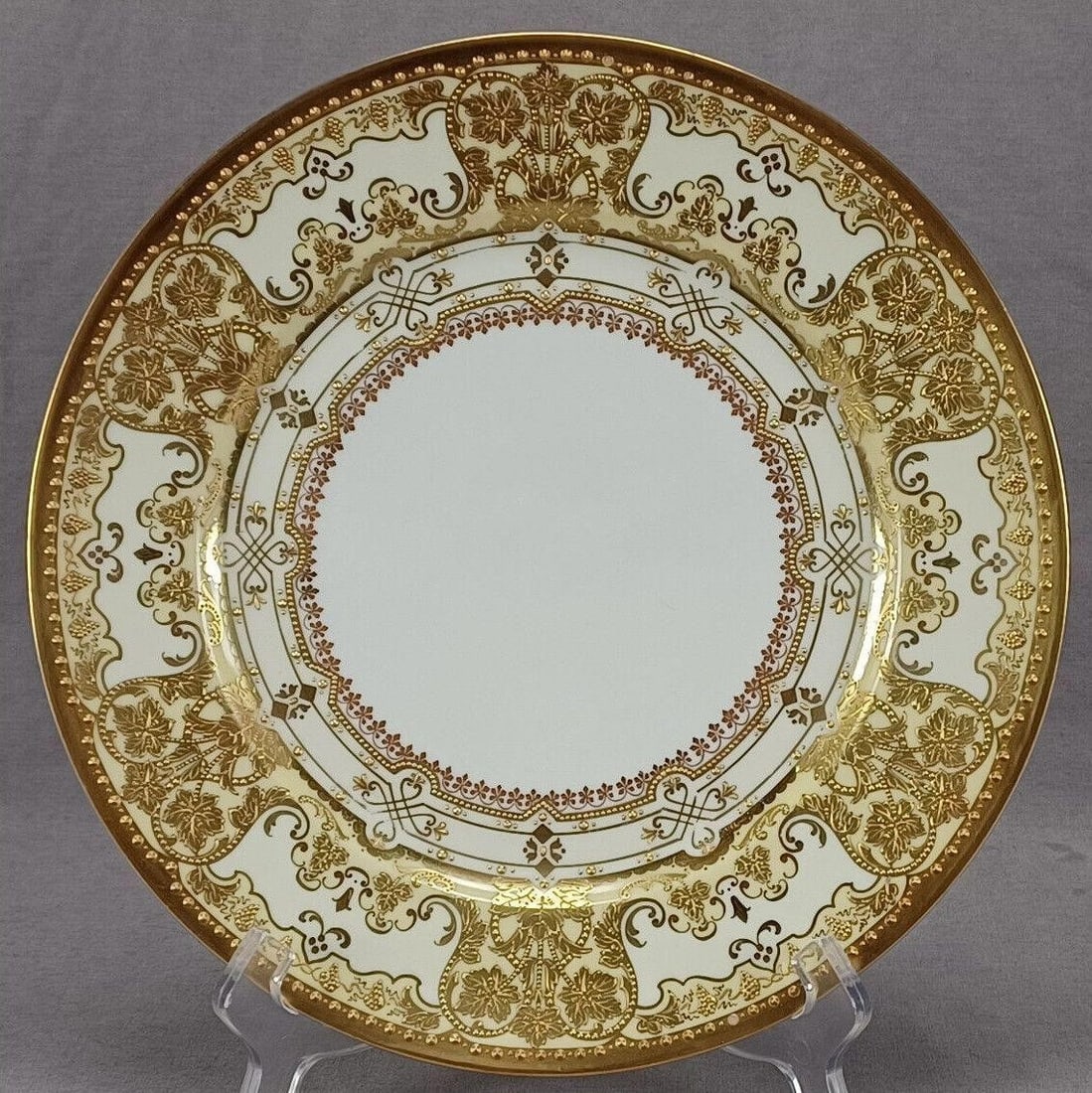 Franziska Hirsch Dresden Beaded Gold Plate D: Beautiful antique porcelain dinner plate. Decorated with a raised and beaded gold grape vine and scrollwork pattern over a white and ivory background. With heavy gold gilding and large and small beads