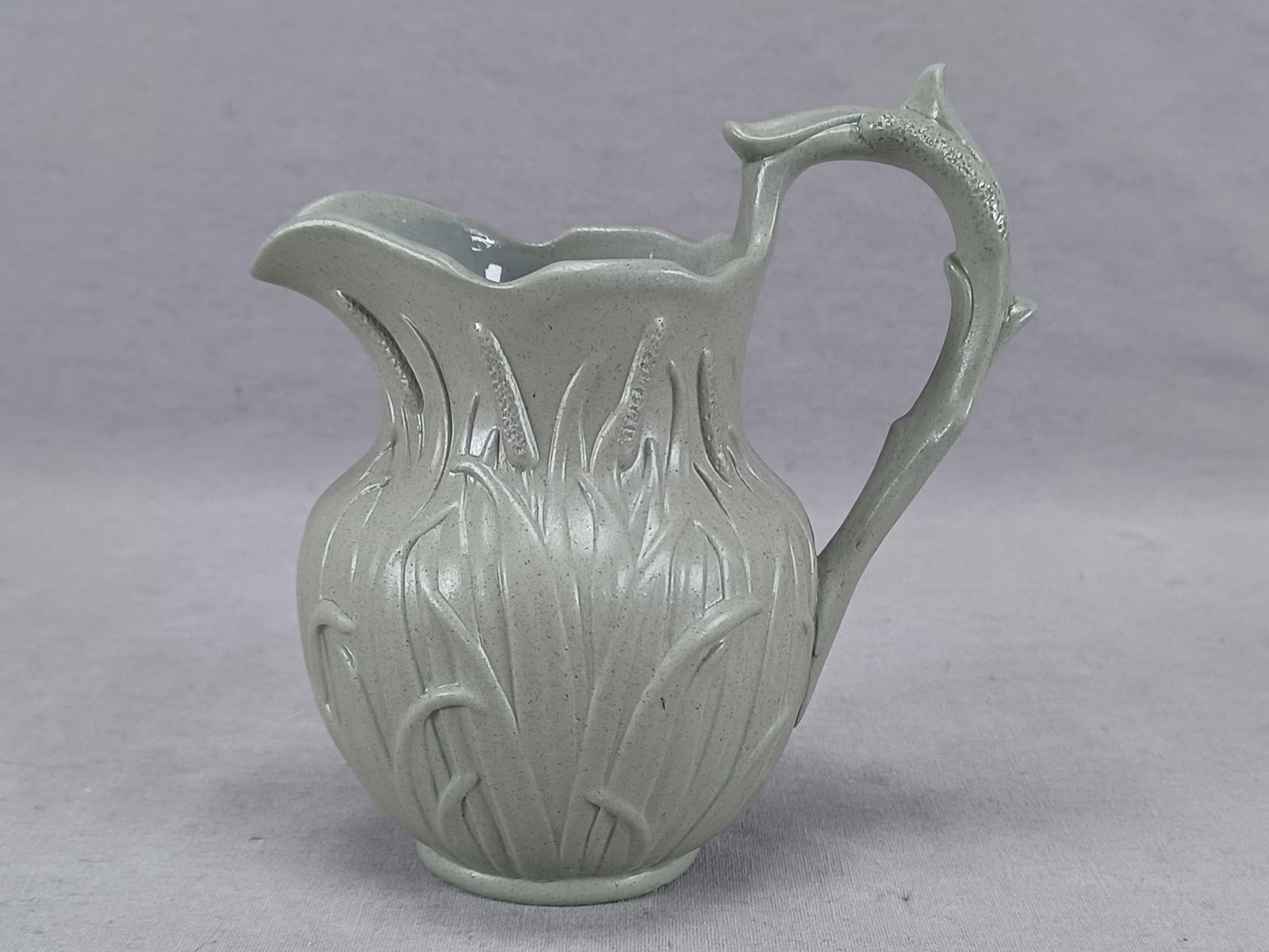 Ridgway Cattails Gray Stoneware Creamer Jug C1840s: British gray smear glazed stoneware creamer or small jug with relief molded Cattail decoration. Unmarked. Made by William Ridgway. Circa 1840s.Has a chip to the top of the handle, and a stacking flake