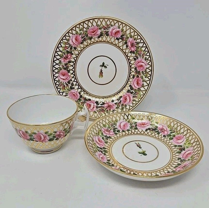 Derby Stevenson & Hancock Cup & Saucer Trio 1860s: Derby Stevenson and Hancock trio with dessert plate, bowl saucer, and footed teacup. Large pink roses with gold lattice pattern and a rose bud in the center. Very good condition without chips or crack