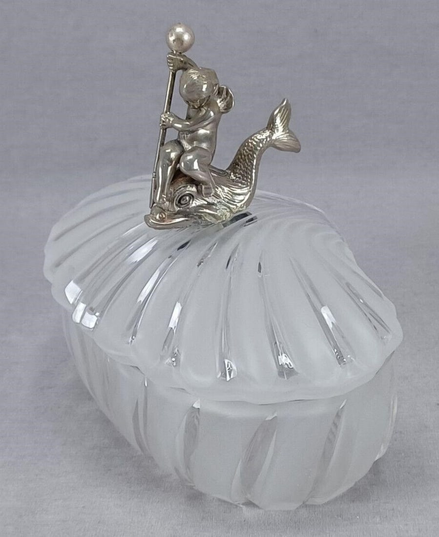 Meriden Silverplate Cherub Dolphin Glass Shell Box: Rare antique pressed, frosted, and cut glass Neoclassical shell shaped box. Has a silverplate finial of a cherub riding a dolphin. The same finial can be found on examples of Meriden silverplate.