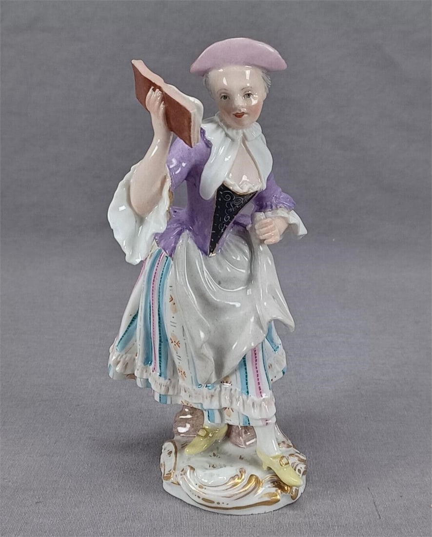 Meissen The Gallant Orchestra Lady Singer Figurine: Nice antique mid 19th century German hand painted porcelain figurine of a female singer from the Gallant Orchestra. Marked on the bottom with a hand painted blue crossed swords mark used by Meissen.Ha