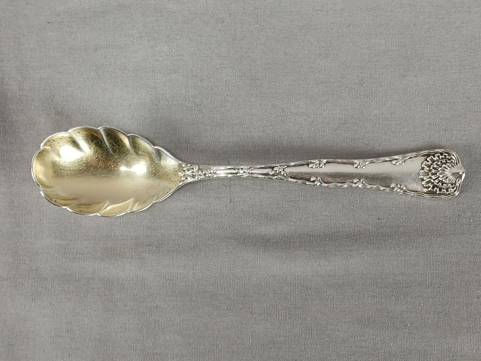 Tiffany Wave Edge Sterling Sugar Shell Spoon: Antique sterling silver spoon in the Wave Edge pattern. Gold washed bowl. Marked on the back of the handle Tiffany Sterling Pat 1884.Has some wear and tarnish, but otherwise good condition.Measures ap