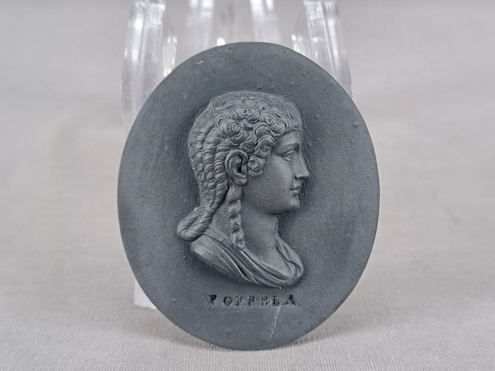 Wedgwood Poppaea Black Basalt Medallion Plaque: Rare antique British black basalt portrait medallion of Poppaea Sabina, wife of Roman Emperor Otho and second wife of Nero. Impressed Poppela below the portrait. Impressed Wedgwood on the reverse. Cir