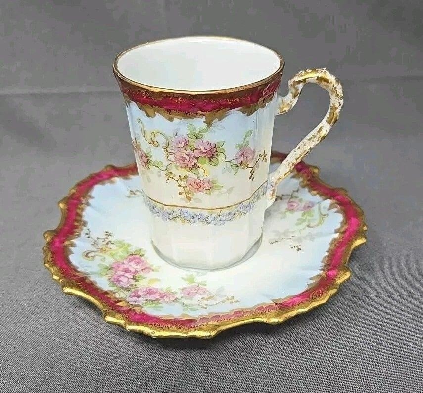 Blakeman & Henderson Chocolate Cup & Saucer: Blakeman & Henderson Limoges Chocolate Cup and Saucer set circa 1900. This is on a Coiffe blank. Decorated with roses Forget-me-nots with maroon and gold border. Also has a light blue fade into birder