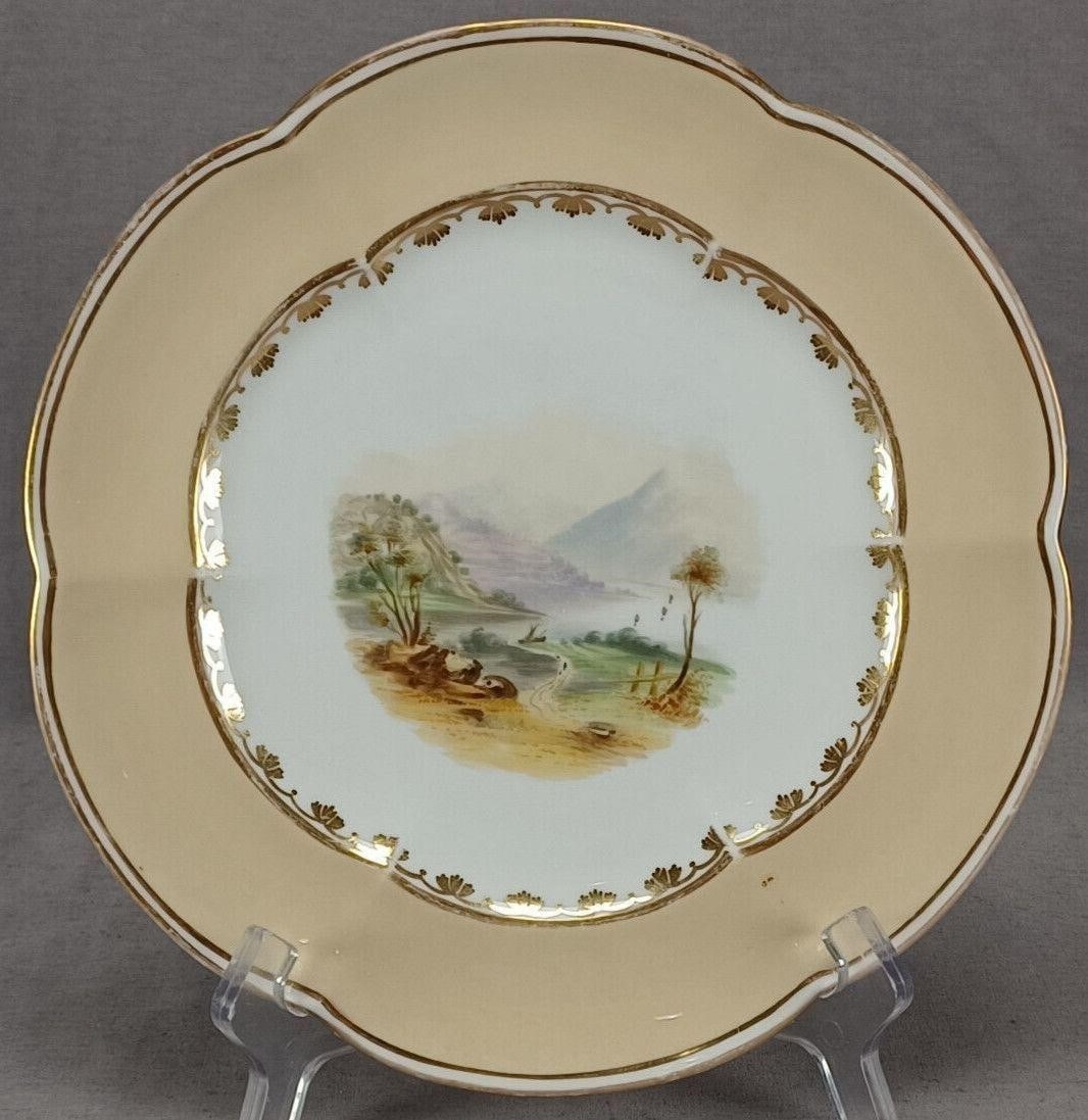 Coalport Hand Painted Landscape 9 1/2" Plate: Antique 19th century Coalport bone china plate. Decorated with a hand painted landscape with a road, rocks, trees, and mountains. Has a beige border with scalloped gold leaves along the inner rim and