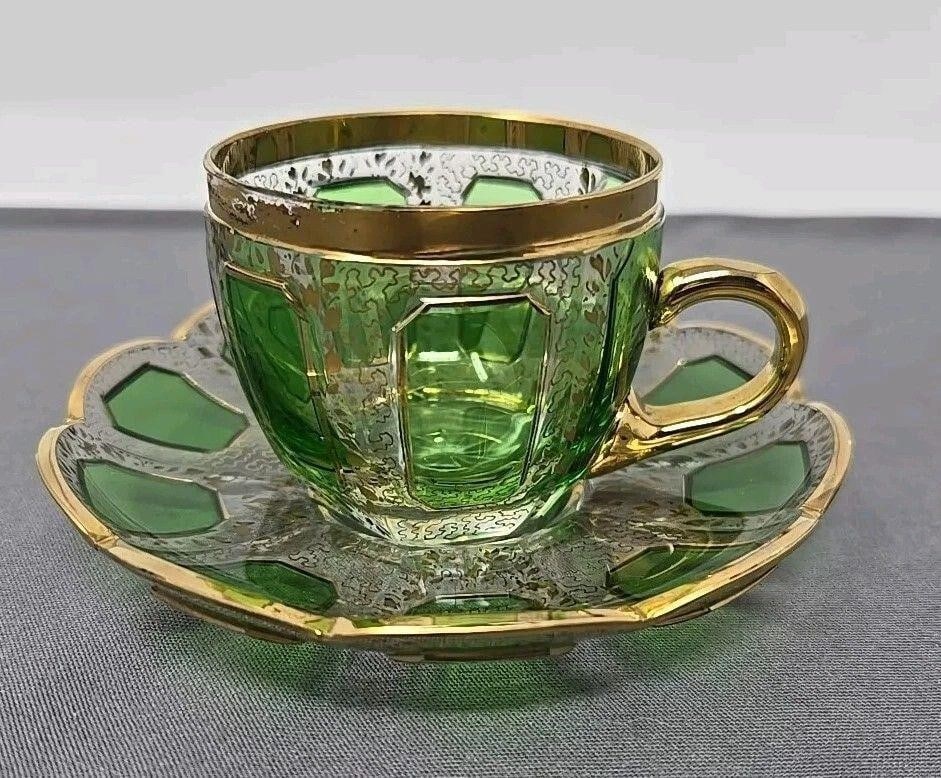 Green Cut to Clear Demitasse Cup & Saucer: Green cut to clear Bohemian Moser style demitasse cup and saucer set. There is an alternating background design of vermicelli and a leaf pattern. Star cut base. Very good condition without chips or cr