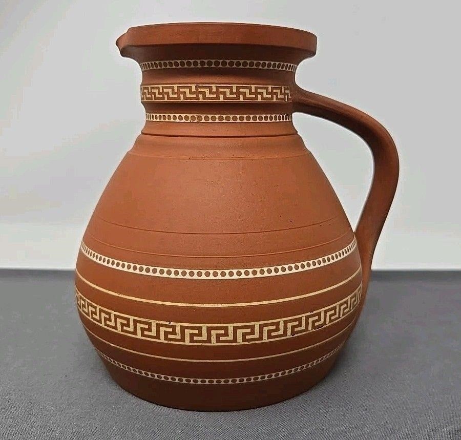 Wedgwood Terracotta Rosso Antico Pitcher c.1850: Wedgwood Rosso Antica Greek Key pattern pitcher. It has a registry mark of November 4th, 1850. Measures approximately 6 inches tall and 5 1/4 inches wide. Very good condition, without chips or cracks.