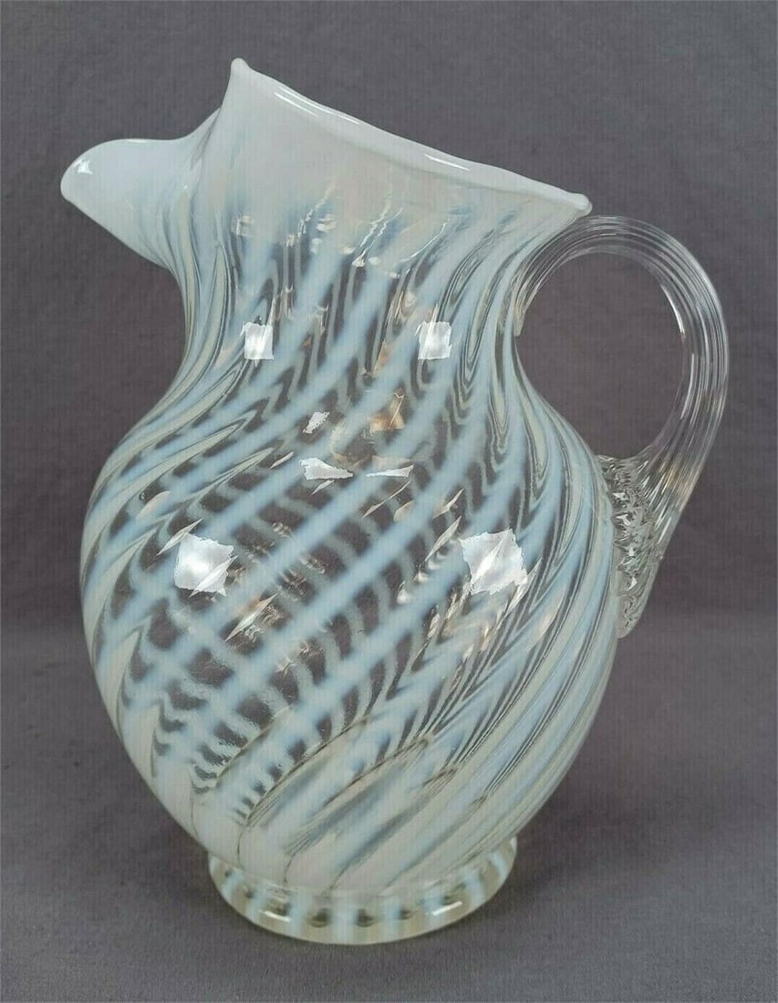 Fenton Spiral Optic Opalescent Swirl 9 1/2"Pitcher: Nice vintage mid century Fenton mold blown pitcher in the Spiral Optic pattern with white opalescent swirl. Unsigned. Circa 1939.Good condition. No chips or cracks.Measures approximately 7 1/2 inches