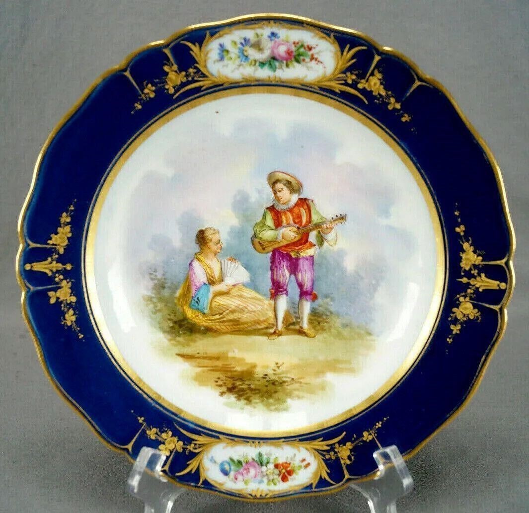 Gosse Old Paris Hand Painted Watteau Scene Plate: Nice antique mid 19th century porcelain plate. Decorated with a hand painted Watteau / Courting couple scene depicting a Renaissance gentleman playing guitar and a lady sitting on the ground with a fa