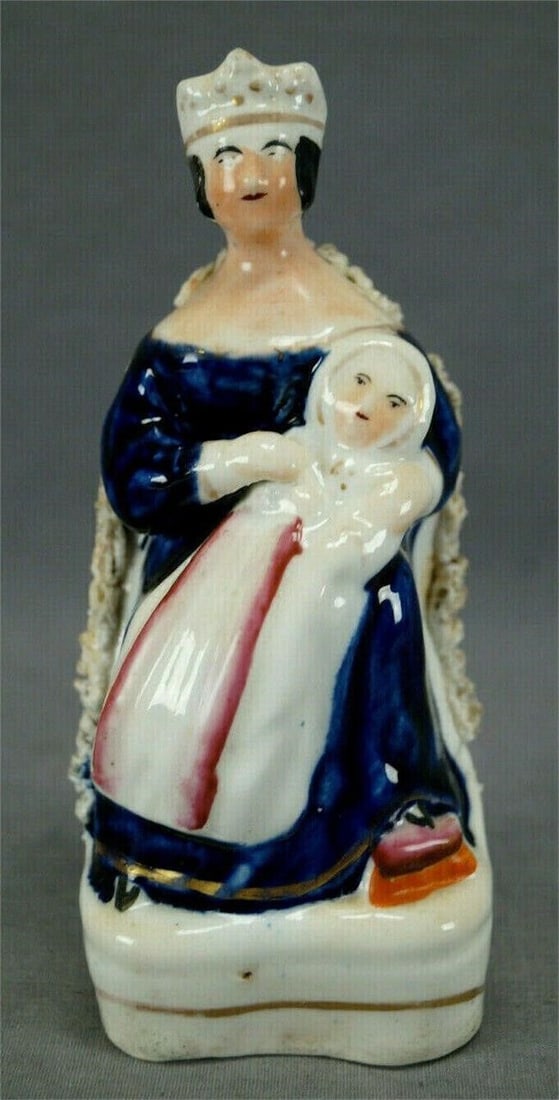 19th Century Queen Victoria Staffordshire Figurine: Mid 19th century hand painted Staffordshire porcelain figurine depicting Queen Victoria with one of her children. Unmarked except for a blue x on the base.Has crazing typical of British porcelain, som