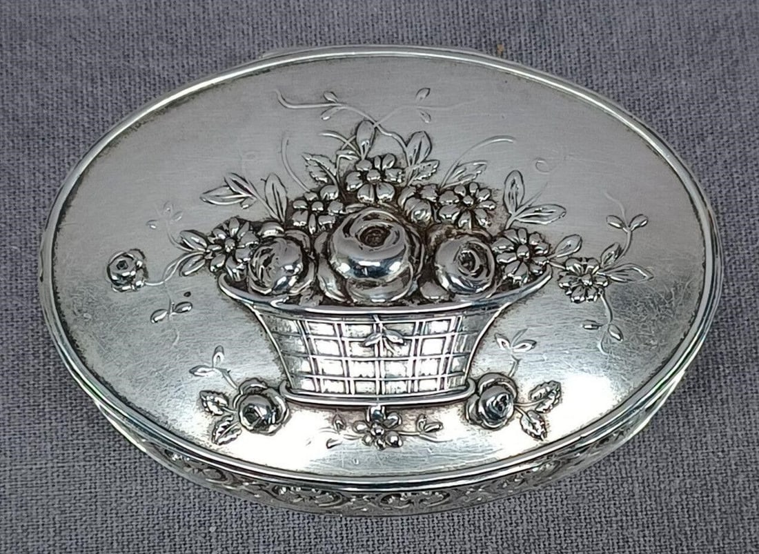 German Hanau 800 Silver Repousse Box C.1880-1910: Nice antique late 19th or early 20th century German 800 silver box. With repousse flowers in basket on the top of the lid and repousse floral design around the sides. Unidentified Hanau hallmarks on t