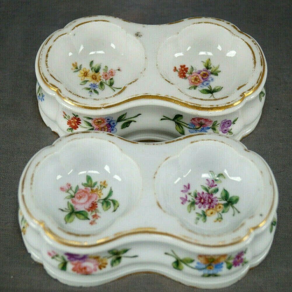 Pair of 18th Century Sevres Hand Painted Salts: Pair of late 18th century hard paste porcelain salts. Decorated with hand painted flowers in pink, red, yellow, purple, and blue. With gold gilding along the edge. Marked on the bottom with the blue c