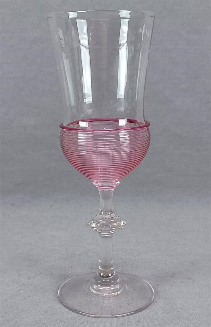 Signed Steuben Ruby Reeding Champagne Flute: Nice antique Steuben champagne flute. Appears to be shape #6360, but has optic molded in the mold. Gold ruby reeding. Ground and polished pontiled base. Signed STEUBEN in block letters on the base. Ci